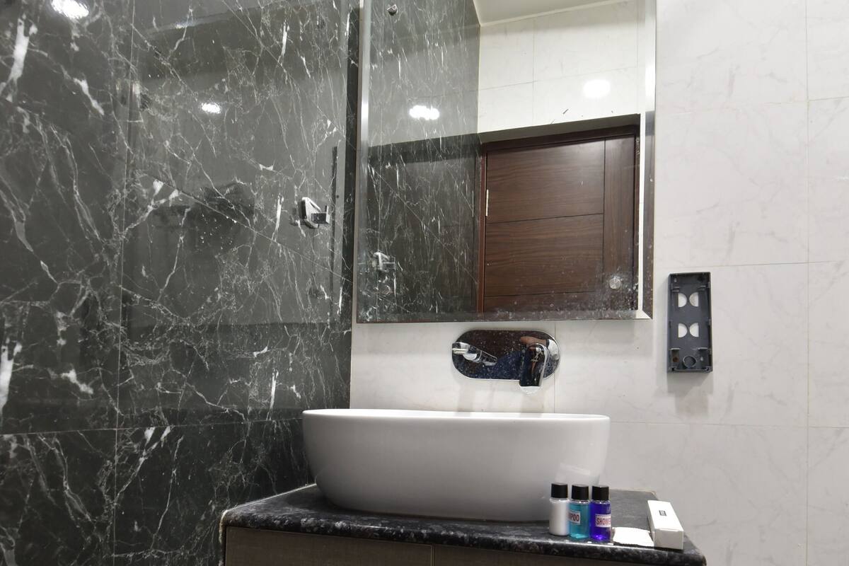 Separate bathtub and shower, towels, soap, shampoo