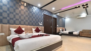 A modern hotel room with a large bed, a sofa, and a wardrobe. - Hotel Pearl Heritage (Jaipur)
