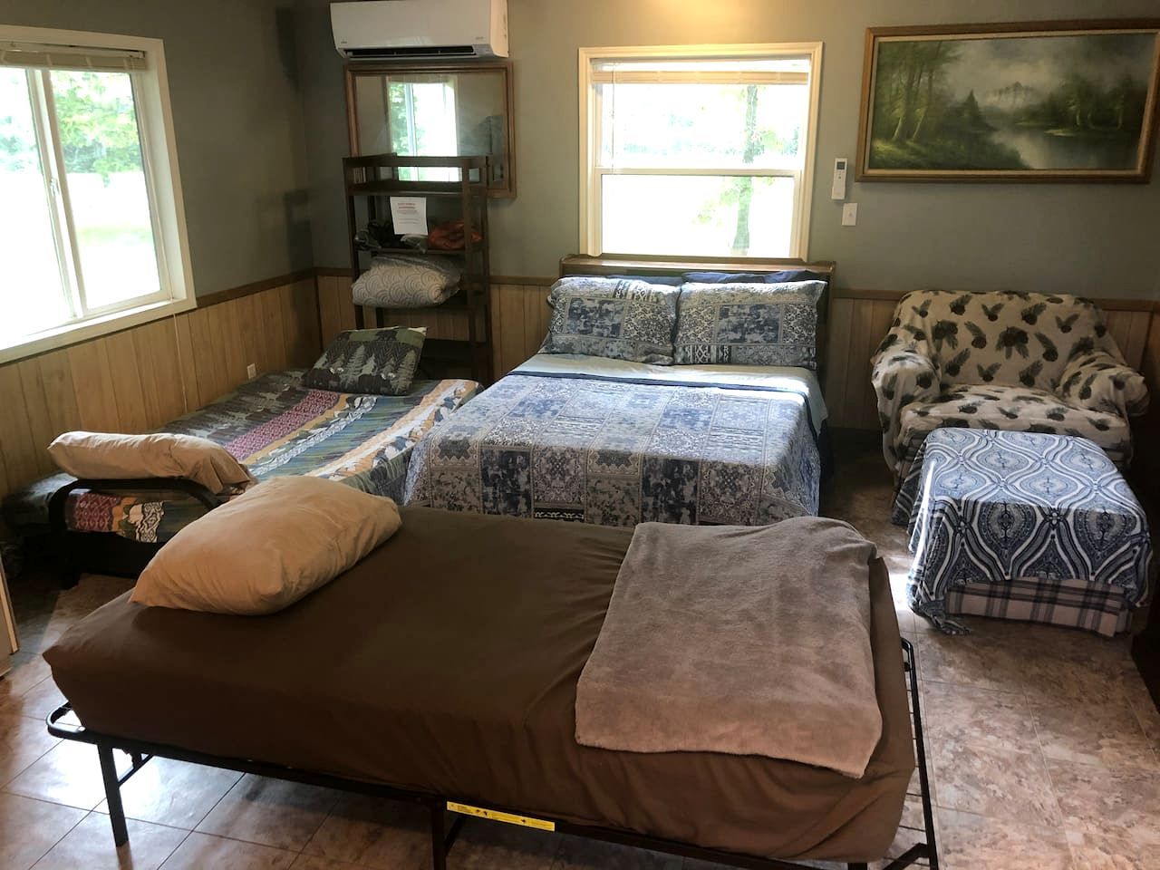 A room with bunk beds, a sofa, and a small table.