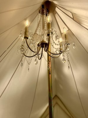 A chandelier with multiple light fixtures and crystal decorations.
