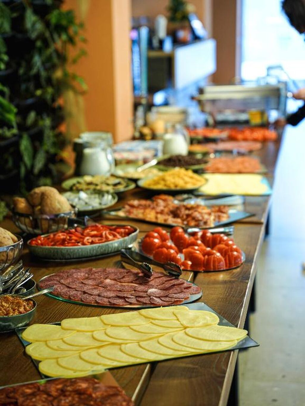 A buffet with various food items and utensils.