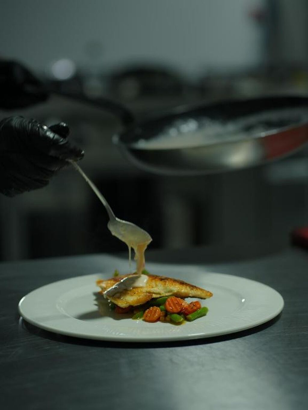 A plate with food, a spoon, and a blurred background.