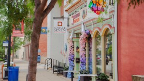 A street view with a coffee house named 'Square Seven Coffee House,' a sign for 'Art Gallery,' and a 'Michael W. Norris, Air Force Lancaster' sign.