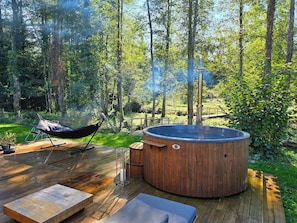 A hot tub on a wooden deck surrounded by a forest. - Stay in an Authentic Water Mill (Condamine)