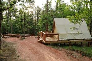 A campsite with a tent, wooden deck, and picnic tables. - Off-Grid A-Frame Tent with Stargazing & Nature Escape in Hermosa, South Dakota (Hermosa)