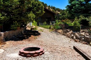 A gravel path leading to a wooden cabin surrounded by trees. - Large, Pet Friendly Cabin for Big Groups near Angel's Landing in Southern, Utah (Cedar City)