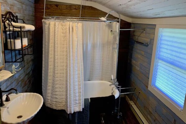 Ein Badezimmer mit Waschbecken, Badewanne und Duschvorhang.