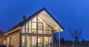 A modern two-story house with large windows and a sloped roof. - Holiday Home 'W 7' with Private Terrace, Private Garden and Wi-Fi (Röbel)