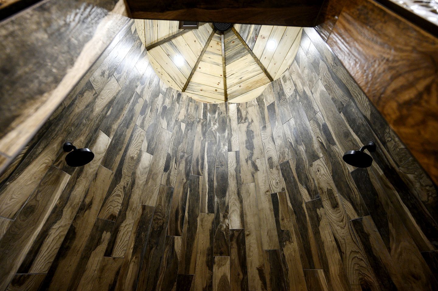 A wooden floor with a central light fixture.