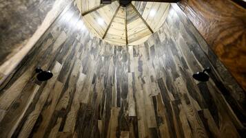 A wooden floor with a central light fixture.