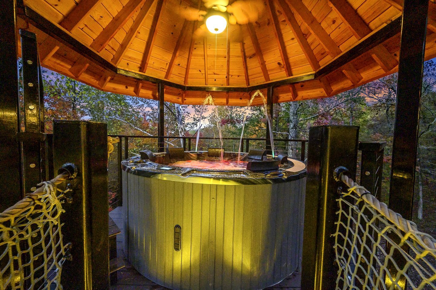 A hot tub with a wooden roof and metal railings.