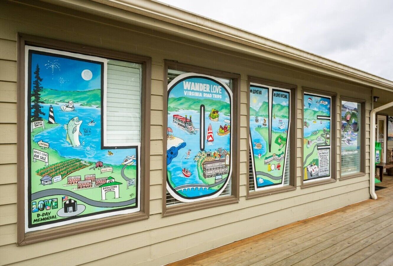 A building facade with large, colorful posters depicting various scenes and activities.