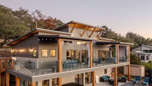 A two-story house with a balcony, outdoor seating, and a swimming pool. - Sleeps 30! Spacious Luxury: Pools, Hot Tubs, Games (Canyon Lake)