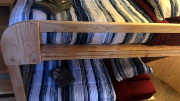 A bunk bed with striped bedding and pillows.