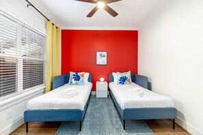 A room with two beds, a ceiling fan, a nightstand, and a window with blinds. - Vibrant Urban Vacation Rental Oasis near Catawba River in North Carolina (Charlotte)