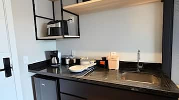 Coffee/tea maker, mini-fridge, stovetop, cookware/dishes/utensils