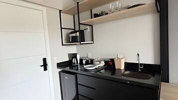 Coffee/tea maker, mini-fridge, stovetop, cookware/dishes/utensils