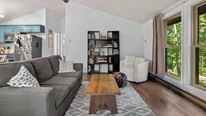 A living room with a sofa, coffee table, and bookshelf.