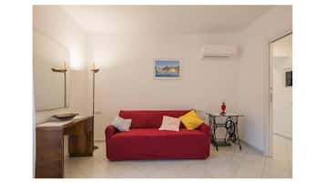Family Apartment, Balcony, City View | Living area | 30-inch Smart TV with satellite channels, toys