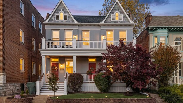 A two-story house with a front porch, a red door, and a well-maintained garden. - Near Forest Park & Central West End - Sleeps 6 (St. Louis)
