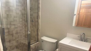 A bathroom with a glass-enclosed shower, a toilet, and a sink with a mirror above. - Ore Station 9: Hot Tub, Ski IN/OUT at Base of Gondola (Telluride)