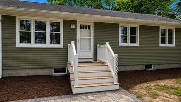 A two-story house with a front porch, a door, and a number '29650' on the side.