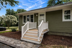 A two-story house with a front porch, a garage, and a mailbox. - Private Pool, Game Room, Near Bethany Beach (Dagsboro)
