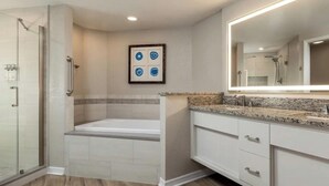 A bathroom with a shower, a bathtub, and a vanity with a mirror. - 2 bedroom condo at Holiday Inn Vacation Club Orange Lake Resort in Kissimmee, FL (Kissimmee)