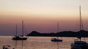 A marina with sailboats at sunset.