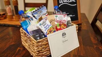 A wicker basket filled with various items including a water bottle, a bag of organic heart healthy mix, and a bag of cranberries.
