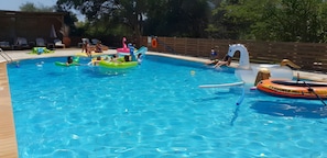A swimming pool with inflatable toys and lounge chairs. - Cozy 2BR Apartment with Pool Access – Apt 9 (Kontokali)