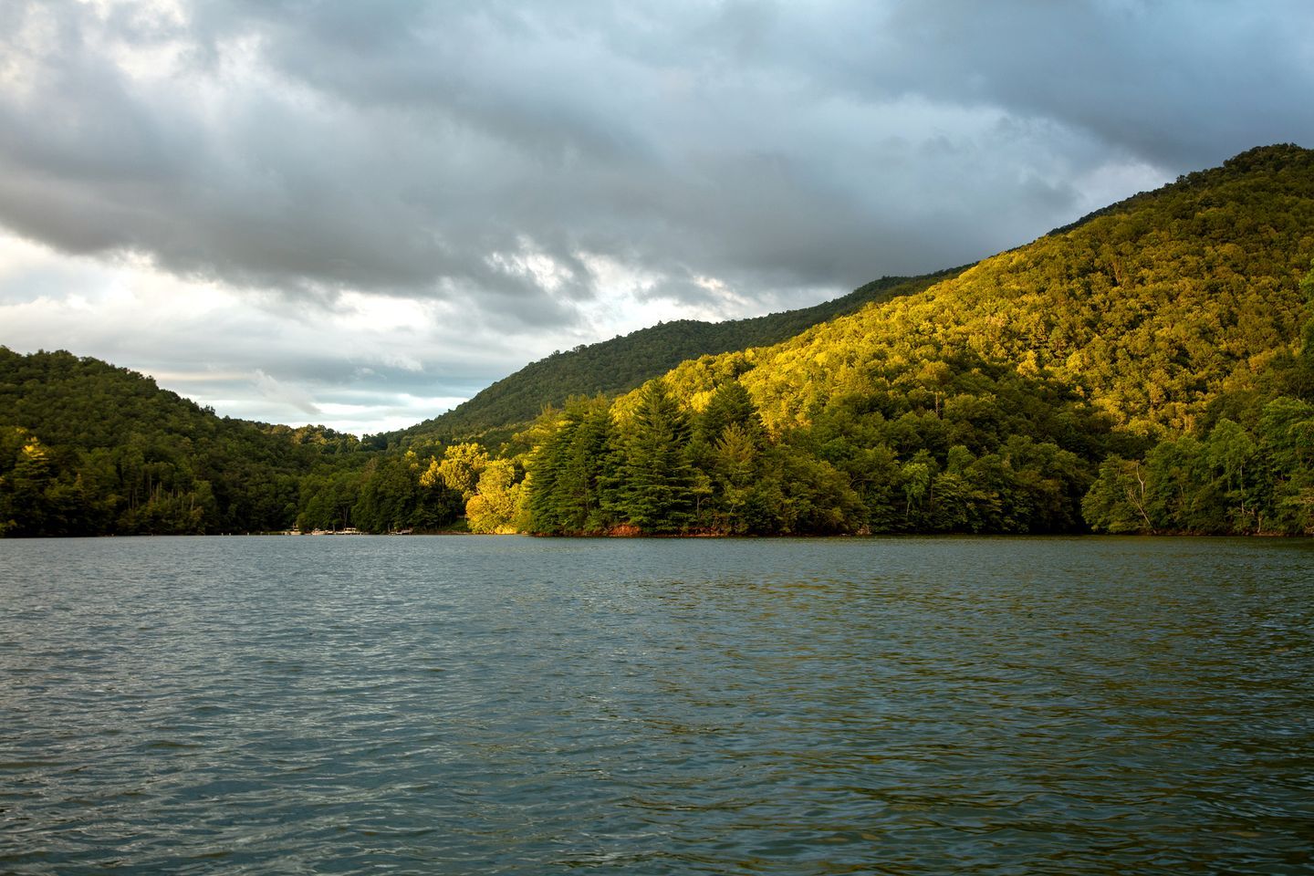 A lake surrounded by forested hills.