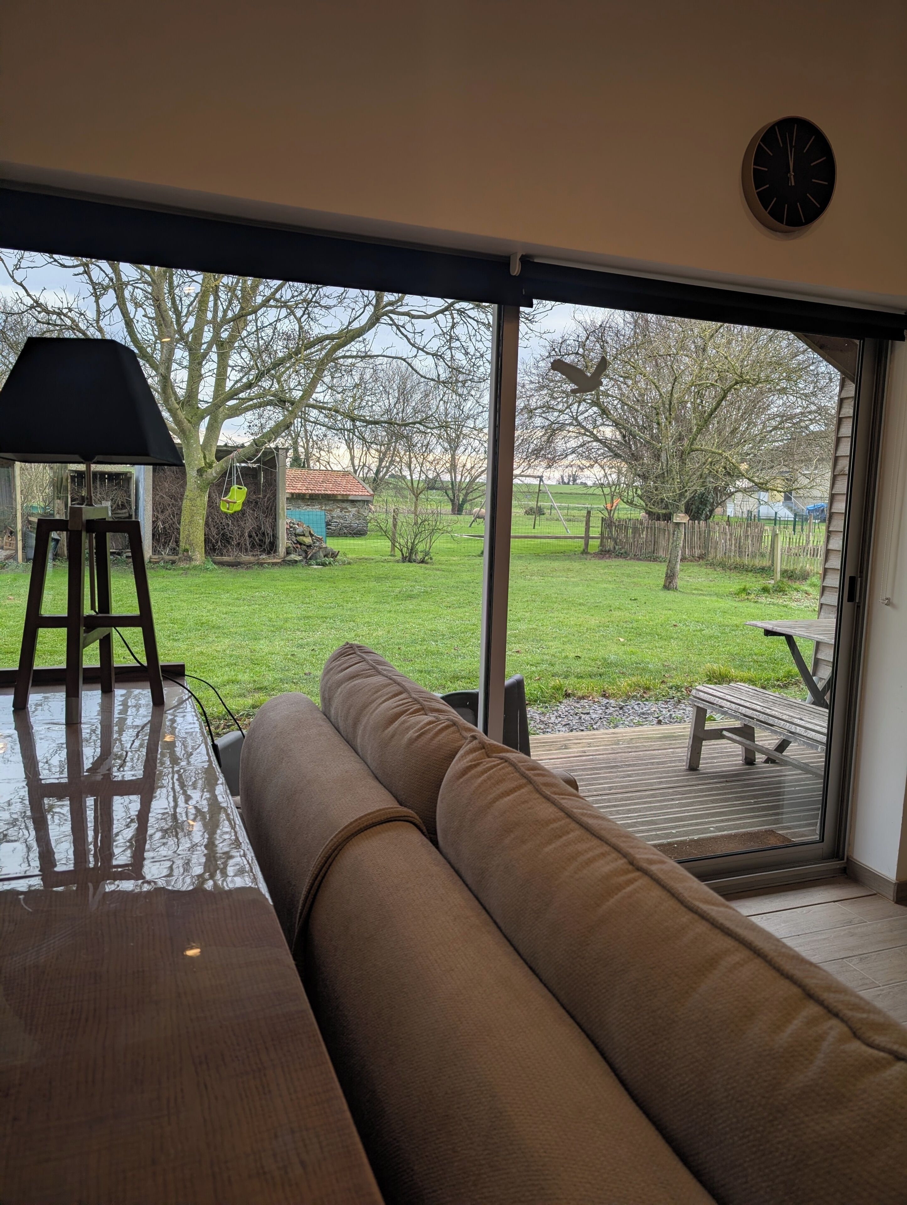 A room with a large sliding glass door leading to a backyard.