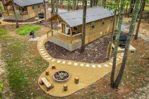 A cabin with a deck, a fire pit, and a covered outdoor seating area. - Charming Forest Cabin with Hot Tub & Covered Porch in Mentone, Alabama (Mentone)