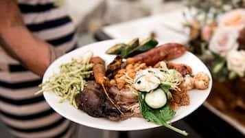 A plate of food with various items including meat, vegetables, and beans.