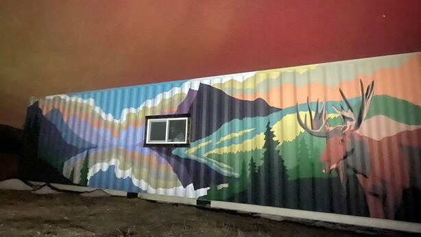 A mural with a mountain and deer on a wall. - Serene Recycled Container in Big Sky Montana, Perfect for a Glamping Weekend in the Wilderness (Ovando)