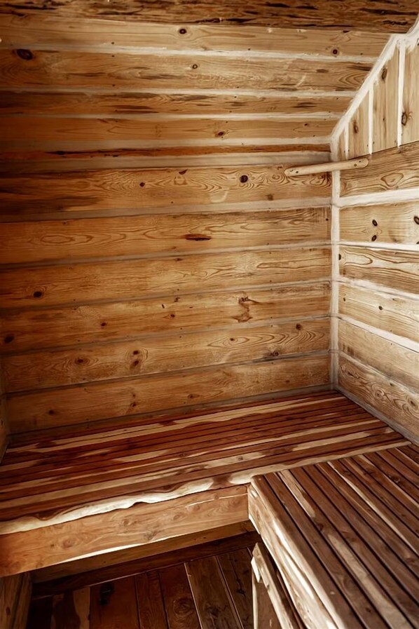 A wooden interior with slatted walls and a bench.