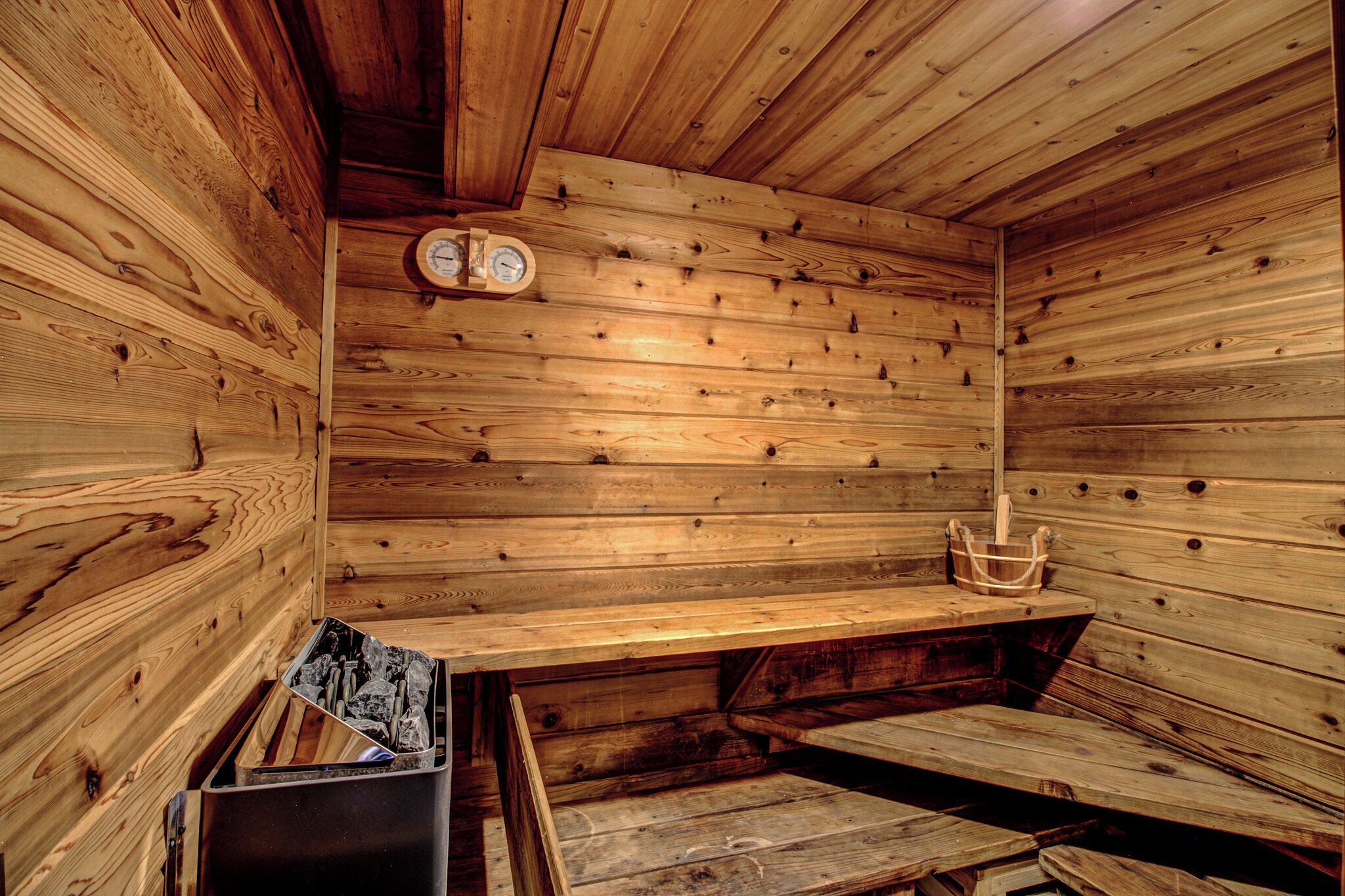 A sauna with wooden walls and a bench.