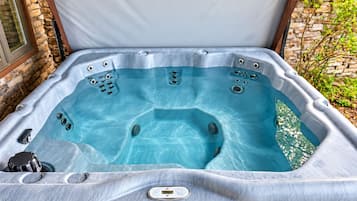 Enjoy spacious seating and soothing massage jets beneath the covered patio.
