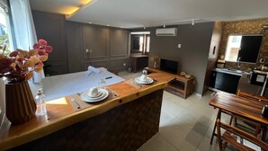 A modern kitchen with a central island, built-in appliances, and a dining area.