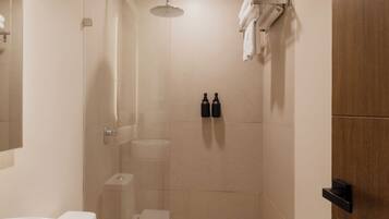 A modern bathroom with a large sink, toilet, and shower.