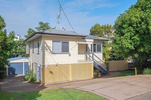 A single-story house with a small porch, a visible antenna, and a garage door. - Verney Beachside Getaway (Kings Beach)
