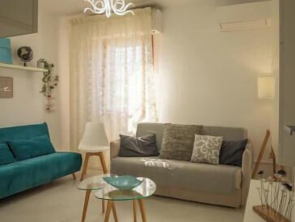 A living room with a sofa, a glass coffee table, and a lamp. - Minerva Royal Suite - Alghero (Alghero)