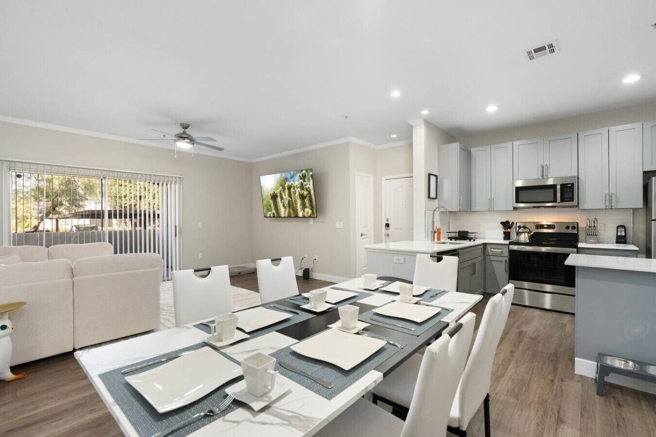 A modern apartment with a dining area, kitchen, and living room.