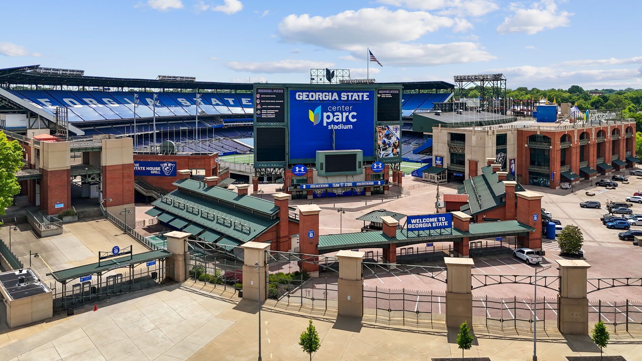 Georgia State Center Parc Stadium with a large blue sign, stadium seating, and a parking area.