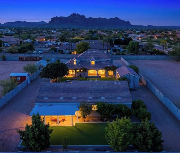 A residential area with a house featuring a flat roof, a front yard, and a mountain in the background. - Mesa Oasis - A rare blend of tranquility and convenience. (Mesa)