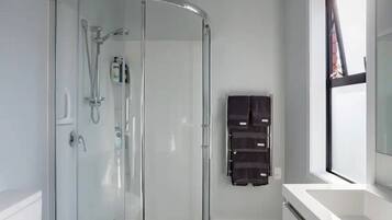 Shower, hair dryer, towels, shampoo