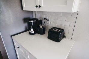 A kitchen with a coffee maker, toaster, and a white countertop. - Grand Gulf Retreat, 5 Bedrooms, Sleeps 13, Garage, Covered Patio (Panama City Beach)