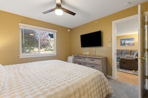 A bedroom with a bed, a television, a desk, and a window. - Ski Big Sky! Hot Tub, Fireplace & Free Shuttle (Big Sky)