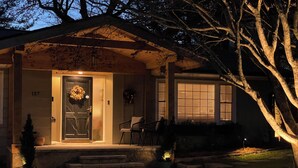 A house with a front door, steps, a porch, and a tree. - Hawthorne Hill (Brevard)